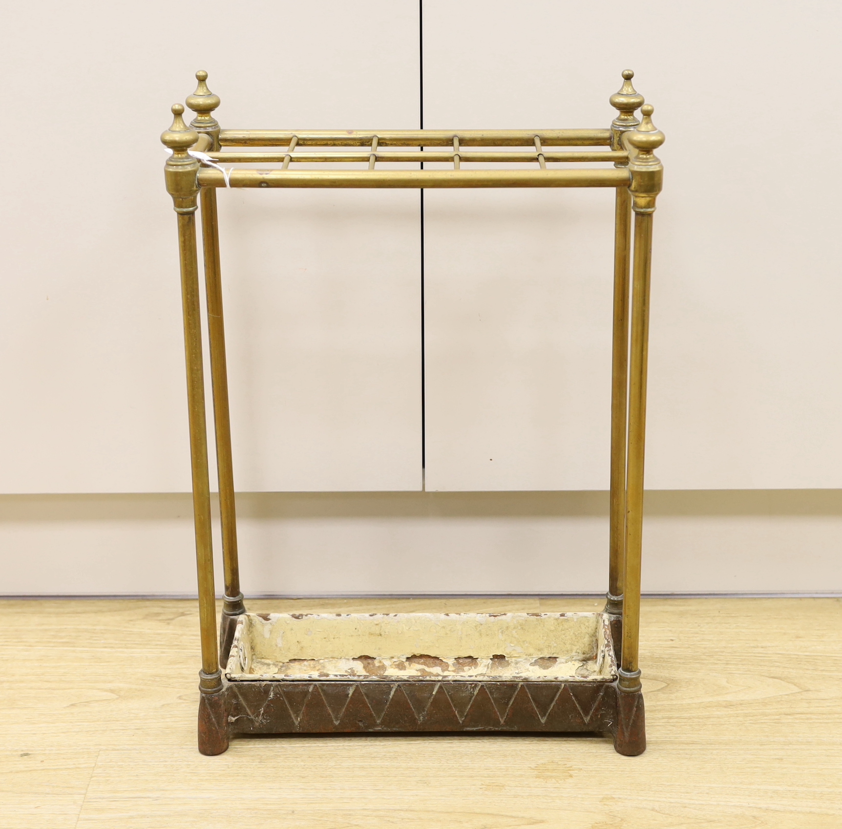 A cast iron and brass stick stand